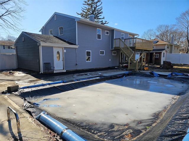 view of swimming pool with stairs, a deck, and fence