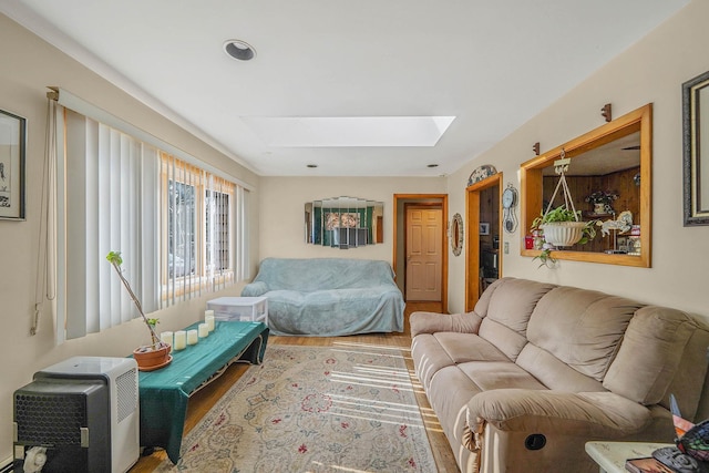 living room with hardwood / wood-style flooring and a skylight