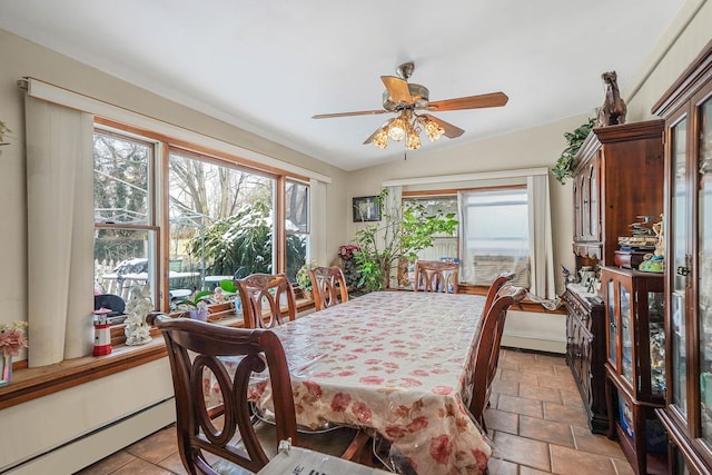 tiled dining area with baseboard heating, ceiling fan, and vaulted ceiling