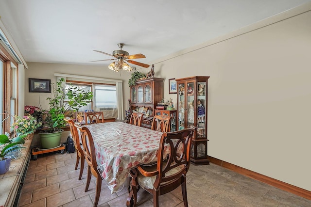 dining area featuring ceiling fan and vaulted ceiling