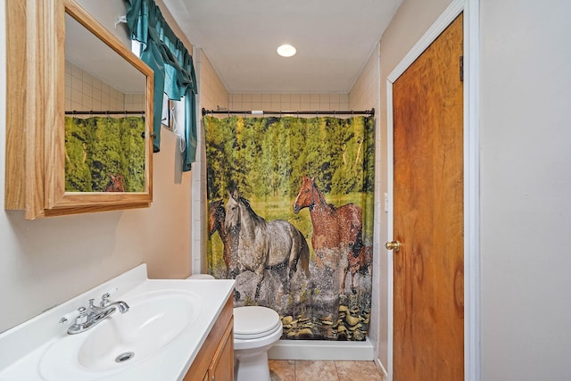 bathroom featuring vanity, toilet, curtained shower, and tile patterned flooring