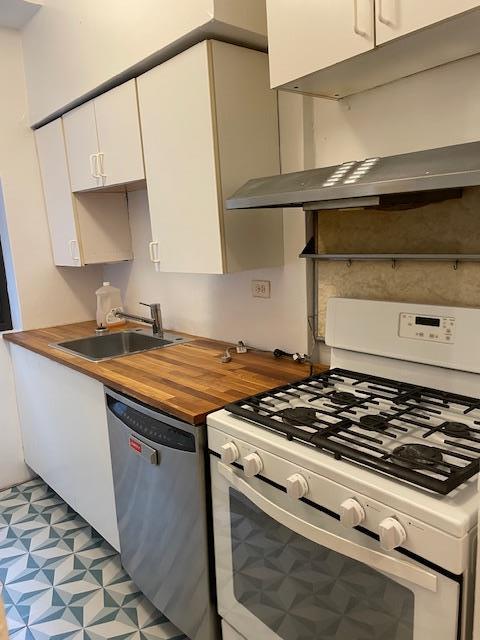 kitchen with sink, stainless steel dishwasher, gas range gas stove, and white cabinets