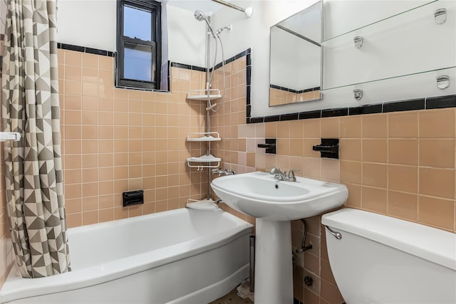 full bathroom with toilet, sink, shower / bath combo with shower curtain, and tile walls