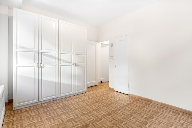 unfurnished bedroom featuring light parquet flooring