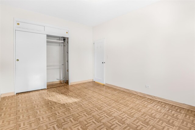 unfurnished bedroom featuring light parquet floors