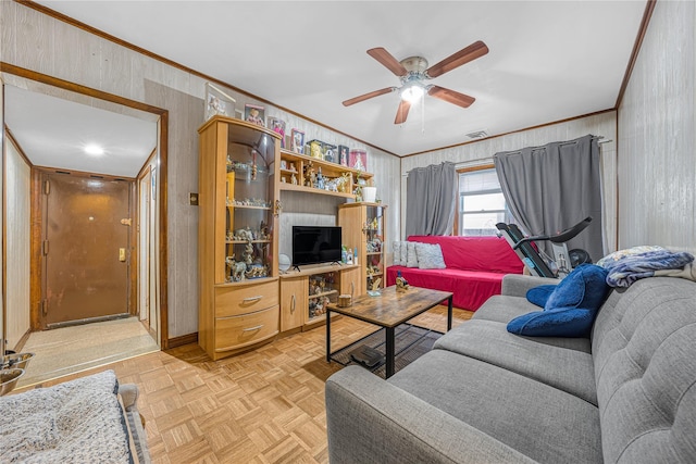 living room featuring ceiling fan, light parquet floors, and crown molding