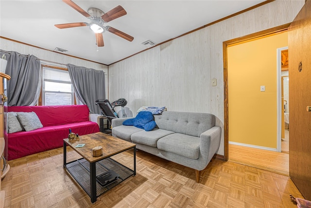 living room featuring ceiling fan, light parquet flooring, and crown molding