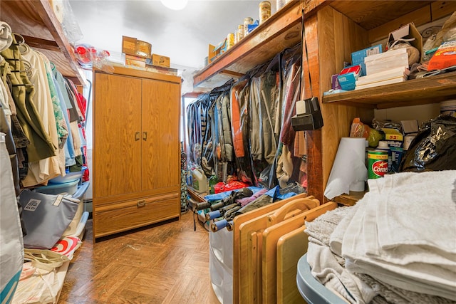 walk in closet with light parquet flooring