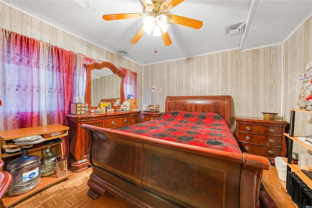 bedroom with light parquet floors, ceiling fan, and ornamental molding