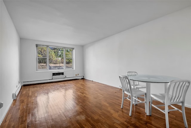 unfurnished dining area featuring baseboard heating and wood-type flooring