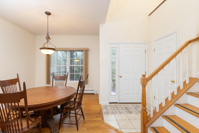 dining room with a baseboard heating unit and light wood-type flooring