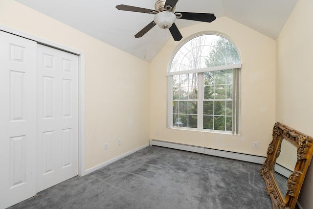 unfurnished bedroom featuring a baseboard heating unit, a closet, dark colored carpet, ceiling fan, and lofted ceiling