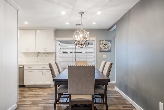 dining space featuring wood-type flooring and an inviting chandelier