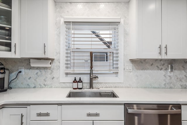 kitchen with sink, white cabinets, tasteful backsplash, and dishwasher