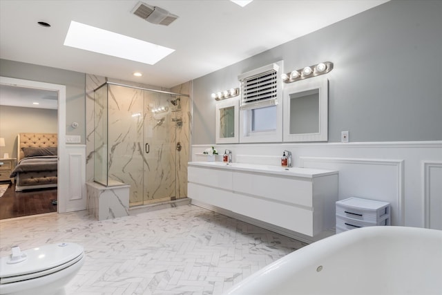 full bathroom with independent shower and bath, a skylight, toilet, and vanity