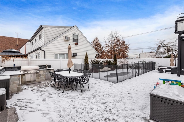 yard covered in snow featuring an outdoor kitchen