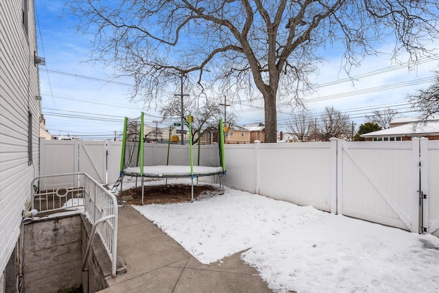 snow covered patio with a trampoline