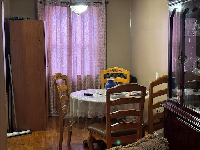 dining space with hardwood / wood-style flooring