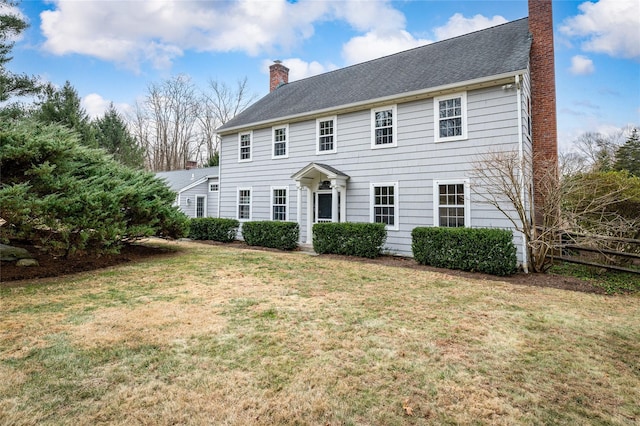 colonial home featuring a front yard