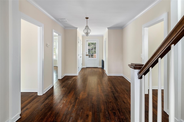 entryway featuring dark wood-type flooring and crown molding