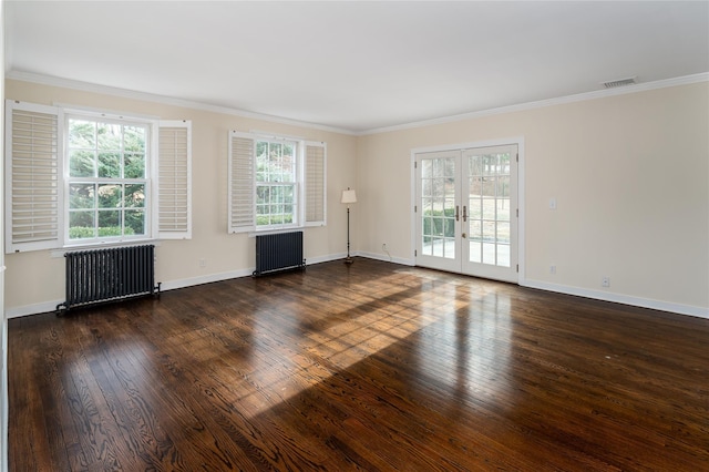 unfurnished room with crown molding, dark hardwood / wood-style floors, radiator heating unit, and french doors