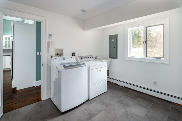 clothes washing area with sink, a baseboard radiator, electric panel, and washing machine and dryer