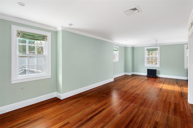 unfurnished living room with hardwood / wood-style floors, crown molding, and radiator heating unit