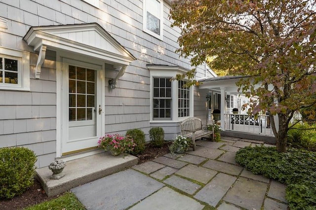 view of exterior entry with a patio