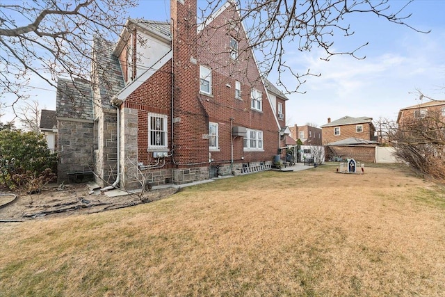 rear view of property featuring a lawn