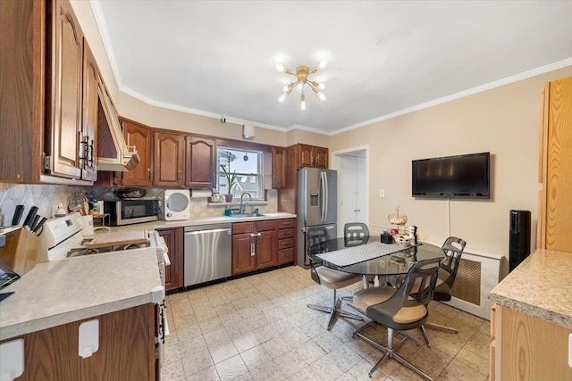 kitchen with crown molding, stainless steel appliances, and sink