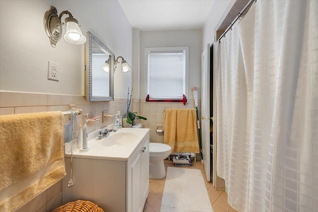 bathroom featuring tile patterned flooring, vanity, toilet, and tile walls