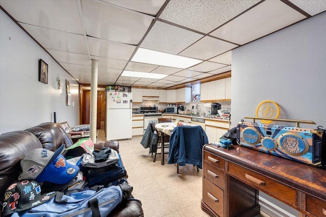 living room featuring a paneled ceiling