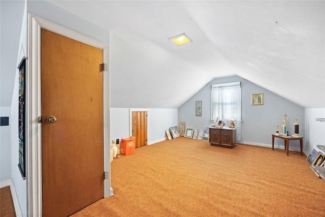 bonus room with lofted ceiling and carpet flooring