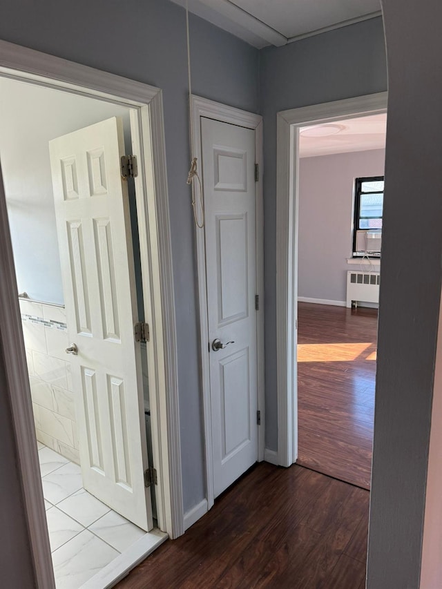 corridor featuring dark hardwood / wood-style floors and radiator