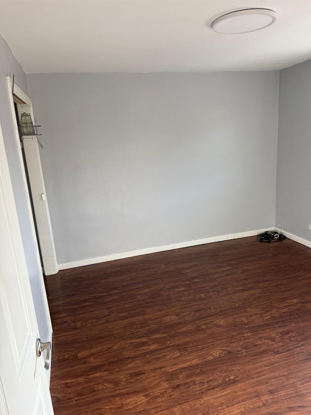 empty room featuring dark hardwood / wood-style flooring