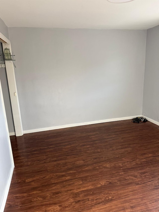 spare room with dark hardwood / wood-style floors