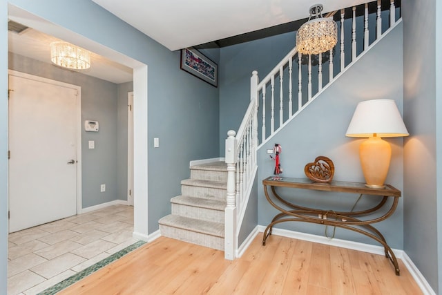 foyer with a chandelier and light hardwood / wood-style floors