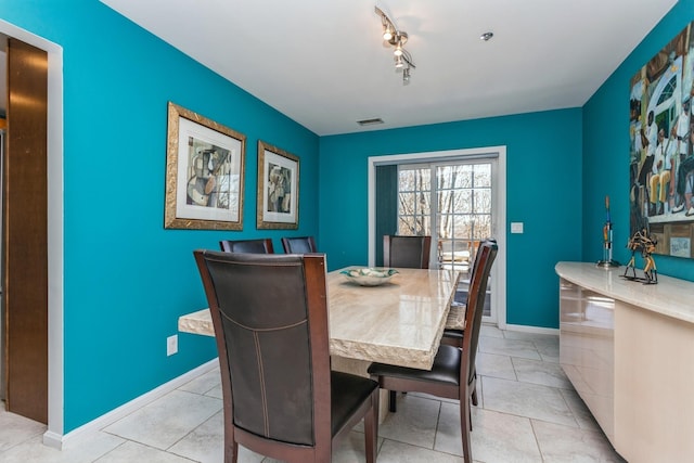 tiled dining area with rail lighting