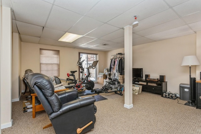 workout room with carpet floors and a paneled ceiling