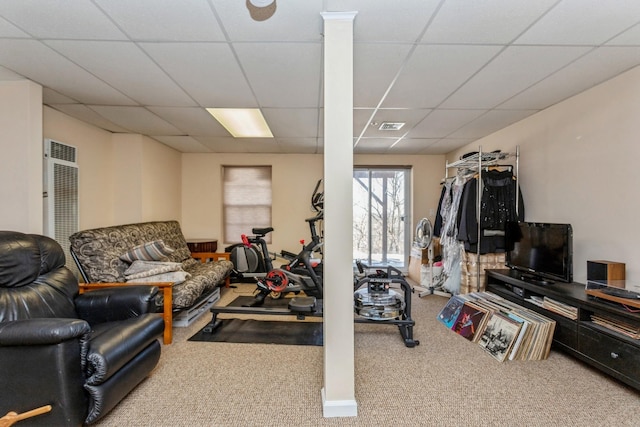 workout room with carpet floors and a drop ceiling