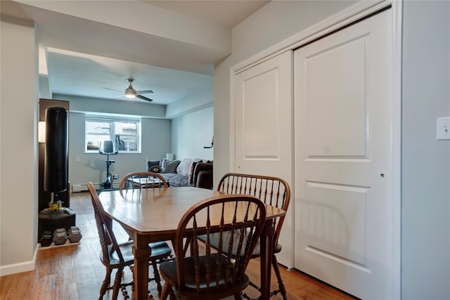 dining space featuring ceiling fan and light hardwood / wood-style flooring