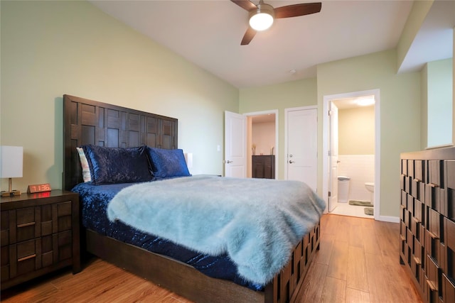 bedroom featuring light hardwood / wood-style floors, ensuite bath, and ceiling fan