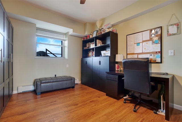 office area with ceiling fan, light wood-type flooring, and a baseboard heating unit