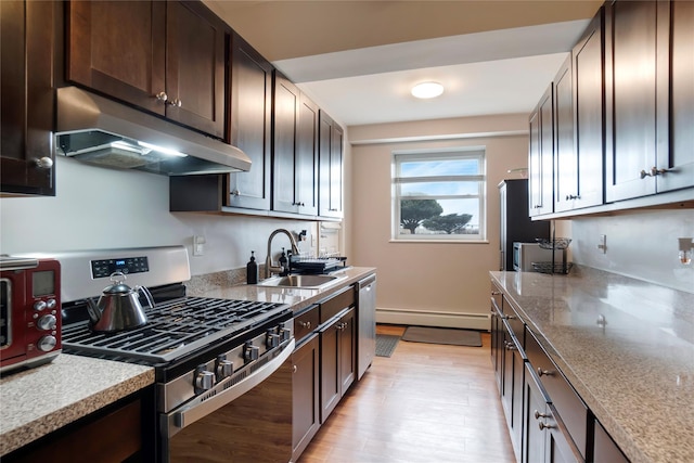 kitchen with sink, a baseboard heating unit, stainless steel appliances, and dark brown cabinets