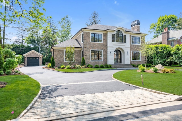 85 Dorchester Dr, Manhasset, NY 11030 - view of front of property featuring asphalt driveway, an outdoor structure, a chimney, a garage, and a front lawn