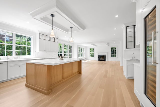 85 Dorchester Dr, Manhasset, NY 11030 - kitchen featuring a center island, light wood-type flooring, light countertops, plenty of natural light, and recessed lighting