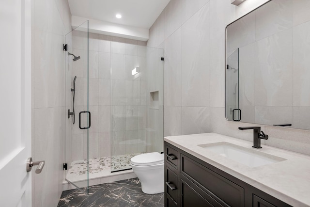 85 Dorchester Dr, Manhasset, NY 11030 - bathroom featuring tile walls, vanity, toilet, marble finish floors, and a shower stall