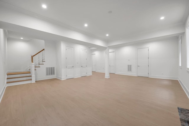 85 Dorchester Dr, Manhasset, NY 11030 - below grade area with baseboards, light wood-type flooring, stairway, recessed lighting, and crown molding