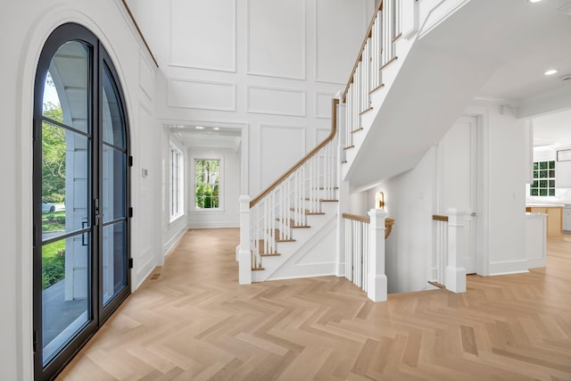 85 Dorchester Dr, Manhasset, NY 11030 - foyer with a decorative wall, a towering ceiling, and stairs