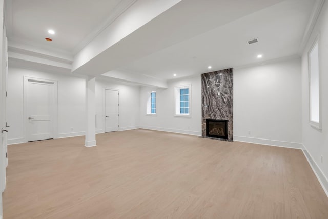 85 Dorchester Dr, Manhasset, NY 11030 - below grade area featuring light wood-style flooring, a premium fireplace, baseboards, crown molding, and recessed lighting